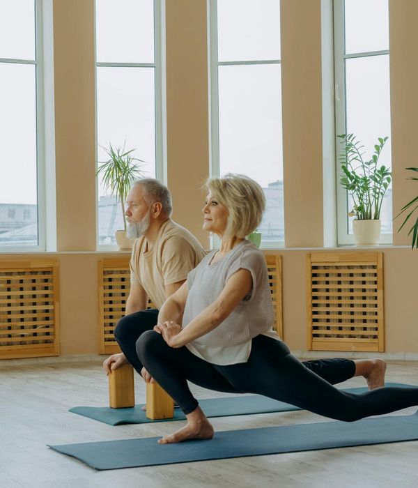 Woman performing a gentle yoga stretch in a calm environment.